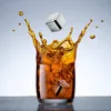 A glass of whiskey with a splash and two stainless steel ice cubes. Produktbild-Vorschau