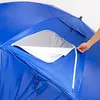 A close-up view of a blue tent or beach shelter, showing a partially opened zippered window with a white inner lining. A hand is visible, holding the zipper pull. Anteprima dell’immagine prodotto
