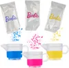 Three packets of Barbie branded powder are shown pouring into three small pitchers, each filled with a different color of liquid. Produktbild-Vorschau