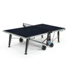 A dark blue outdoor table tennis table with a net, shown from a slightly elevated side angle against a white background. Produktbild-Vorschau