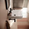 A modern bathroom sink with a black faucet and a small pink tray with soap and a brush. Anteprima dell’immagine prodotto