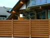 A wooden fence in front of a modern house. Produktbild-Vorschau