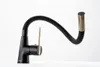 A black and gold kitchen faucet with a flexible hose is shown against a white background. Produktbild-Vorschau