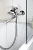 A close-up shot of a chrome bathtub faucet with water running into the tub. Náhľad obrázku produktu