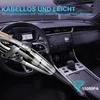 A hand holding a cordless vacuum cleaner inside a car. Produktbild-Vorschau