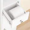 A close-up view of an open drawer in a white cabinet, revealing a roll of toilet paper inside. Náhled obrázku produktu