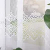 A close-up view of a white lace curtain with a decorative pattern. Náhled obrázku produktu