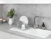 A kitchen sink area with a dish rack filled with dishes, a faucet, and a soap dispenser. Anteprima dell’immagine prodotto