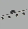 A black track light fixture with four adjustable spotlights against a plain gray background. Podgląd zdjęcia produktu