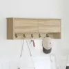 A wall-mounted cabinet with hooks for hanging items. Voir les images du produit