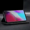 A smartphone in a black flip case, standing upright on a textured surface. Produktbild-Vorschau