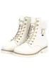 A pair of white lace-up boots with faux fur trim. Produktbild-Vorschau