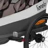 A close-up view of a child trailer's wheel and side panel. Produktbild-Vorschau