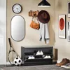 An entryway with a shoe cabinet, mirror, clock, coat rack, and artwork. Produktbild-Vorschau