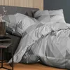 A close-up view of a bed with geometric patterned bedding. Produktbild-Vorschau