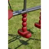 A close-up view of a red swing set seat and its chain, resting on green grass. Produktbild-Vorschau