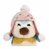A close-up of a plush toy bird wearing a pink hat with white pom-poms. Voir les images du produit