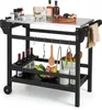 A black grill cart with a stainless steel top, stocked with various items like wine bottles, food, and utensils. Produktbild-Vorschau