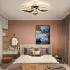 A bedroom with a bed, dresser, and closet, featuring a modern ceiling light. Voir les images du produit