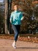 A woman is jogging in a park during autumn. Anteprima dell’immagine prodotto