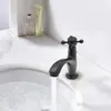 A black faucet in a bathroom sink with water running. Produktbild-Vorschau