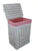 A white wicker laundry basket with a pink fabric liner and an open lid, shown against a white background. Podgląd zdjęcia produktu