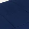 A close-up view of a quilted navy blue fabric. Náhled obrázku produktu