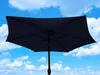 A dark blue rectangular umbrella is silhouetted against a bright blue sky with white clouds. Anteprima dell’immagine prodotto