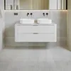 A modern white bathroom vanity with two sinks and a mirrored wall. Náhled obrázku produktu