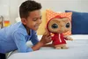 A young boy is playing with an E.T. plush toy on a bed. Produktbild-Vorschau