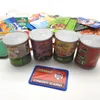 A collection of toy food cans and packaging, along with a toy credit card, arranged on a white surface. Produktbild-Vorschau