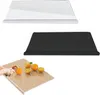 Three different cutting boards are shown, one clear, one black, and one with a wood grain pattern with oranges and a hand cutting one. Produktbild-Vorschau