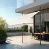 An outdoor patio with a dining table and chairs, shaded by a retractable awning. Náhled obrázku produktu