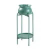 A green plant stand with a matching pot and a round shelf, shown against a white background. Podgląd zdjęcia produktu