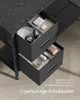 A close-up view of two open drawers of a black desk, showing office supplies and accessories. Produktbild-Vorschau