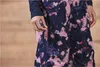 Close-up of a person's hand zipping up a pocket on a pair of patterned ski pants. Produktbild-Vorschau