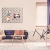 A living room scene with a sofa, coffee table, and a bicycle. Voir les images du produit