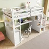 A white loft bed with a desk and storage is shown in a room with light green walls and a light-colored rug. Produktbild-Vorschau