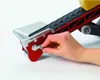 A hand is shown adjusting a crank on a toy conveyor belt. Náhled obrázku produktu