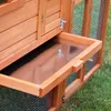 A close-up view of a wooden animal hutch with a pull-out tray. Produktbild-Vorschau