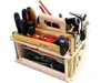 A wooden toolbox filled with various tools, presented against a white background. Produktbild-Vorschau