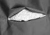 A close-up view of a gray fabric with a zipper partially open, revealing white polystyrene beads inside. Produktbild-Vorschau