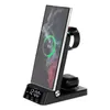 A black 4-in-1 wireless charging station with a smartphone, smartwatch, and earbuds charging. Produktbild-Vorschau