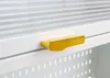 A close-up shot of a gold handle on a white cabinet. Anteprima dell’immagine prodotto