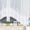 A white jacquard curtain with a decorative pattern is shown hanging over a window. Náhled obrázku produktu