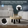 A coffee table with black legs and a wooden top, placed on a rug in a living room setting with a sofa in the background. The image includes informational callouts about the product's features. Náhľad obrázku produktu