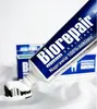 A tube of Biorepair toothpaste with toothpaste squeezed onto a toothbrush. Produktbild-Vorschau
