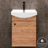 A bathroom vanity with a sink and faucet against a tiled wall. Produktbild-Vorschau