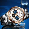 A close-up shot of a men's wristwatch with a white face, rose gold bezel, and silver band, set against a blue background. Produktbild-Vorschau