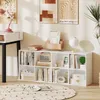 A white bookshelf filled with books, decorative items, and a radio, placed in a room with artwork on the wall and a rug on the floor. Produktbild-Vorschau